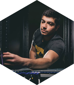 Hexagon image displaying a male Purdue student working on a computer!