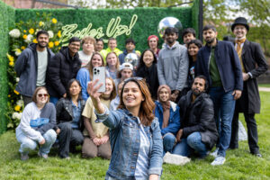 Featured image shows Purdue students posing for a selfie with a 'Boiler Up' sign in the background during the Purdue Day of Giving celebration.